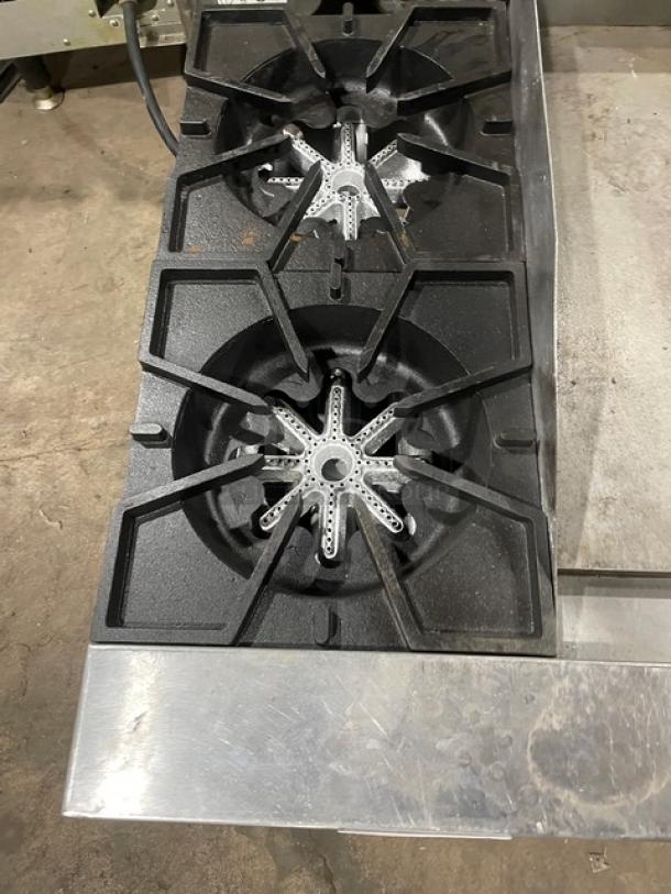 Comstock-Castle stainless steel 2-burner griddle range, Model FHP36-24, features split top and splash guards, on legs.