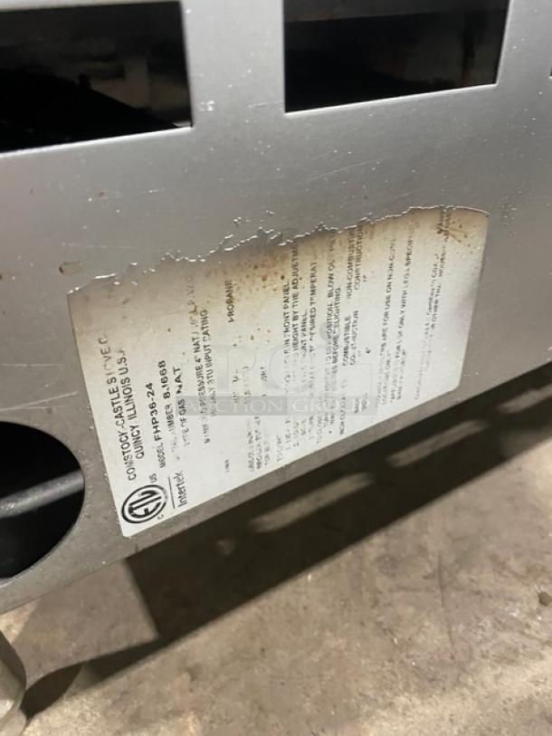 Comstock-Castle stainless steel countertop griddle range, model FHP3624, with leg support, visible maker's label.