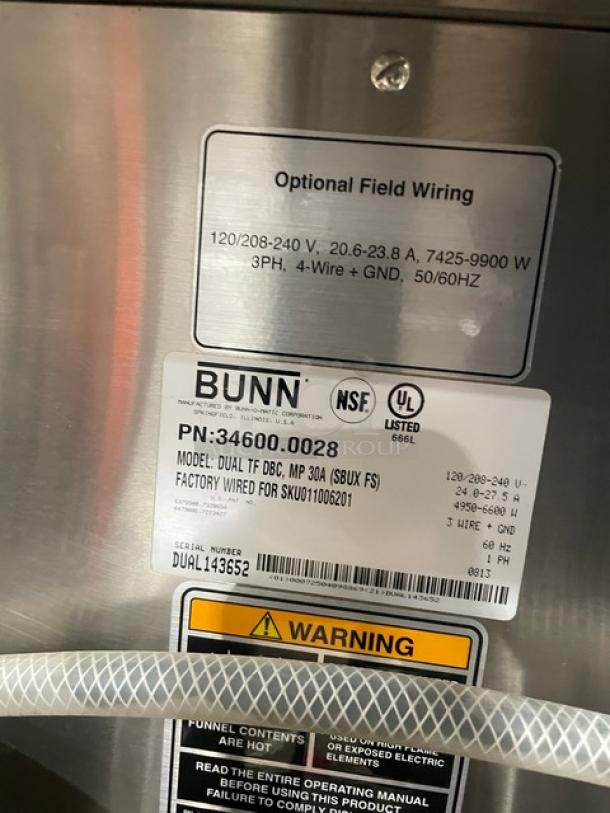 Bunn ThermoFresh DUALTFDBC Commercial Stainless Steel Dual Coffee Brewer with digital control, hot water dispenser, tags showing model info and warnings.