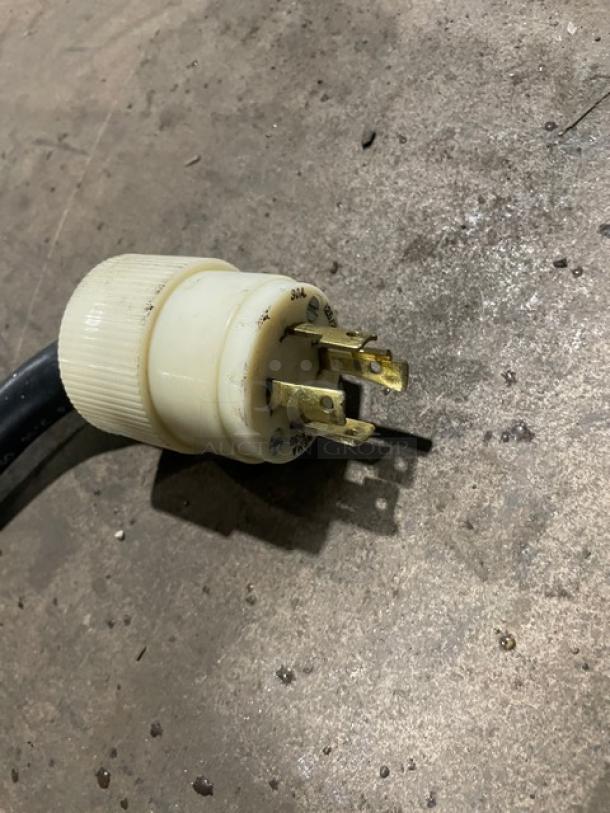 Close-up of the electrical plug for a Bunn ThermoFresh DBC Series coffee brewer, model DUALTFDBC, showing three-prong design.