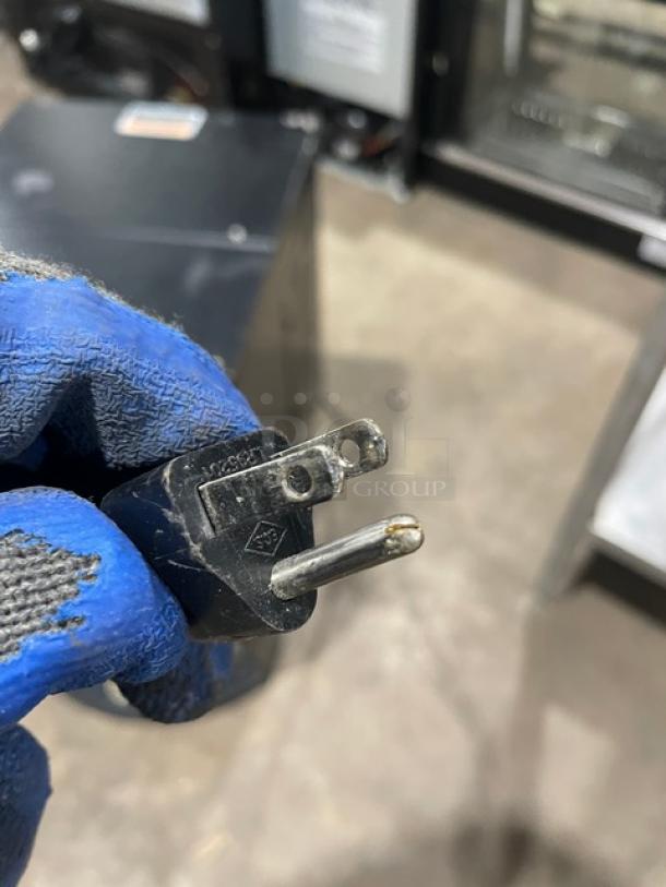 Close-up of a power plug for a Bunn LCC2LP commercial coffee dispenser, showing prongs and black casing.