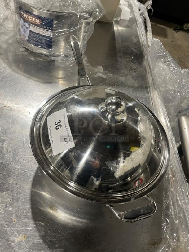 Commercial stainless steel kitchen pan with lid. Features a gray grip handle. Item marked with a "36" label.