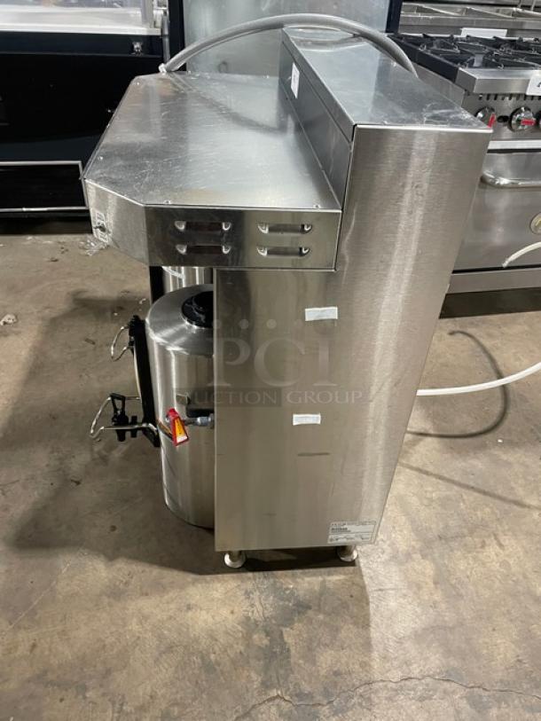 Fetco CBS-62H stainless steel commercial twin coffee brewer with hot water dispenser, model CBS62H, 240V, on legs.