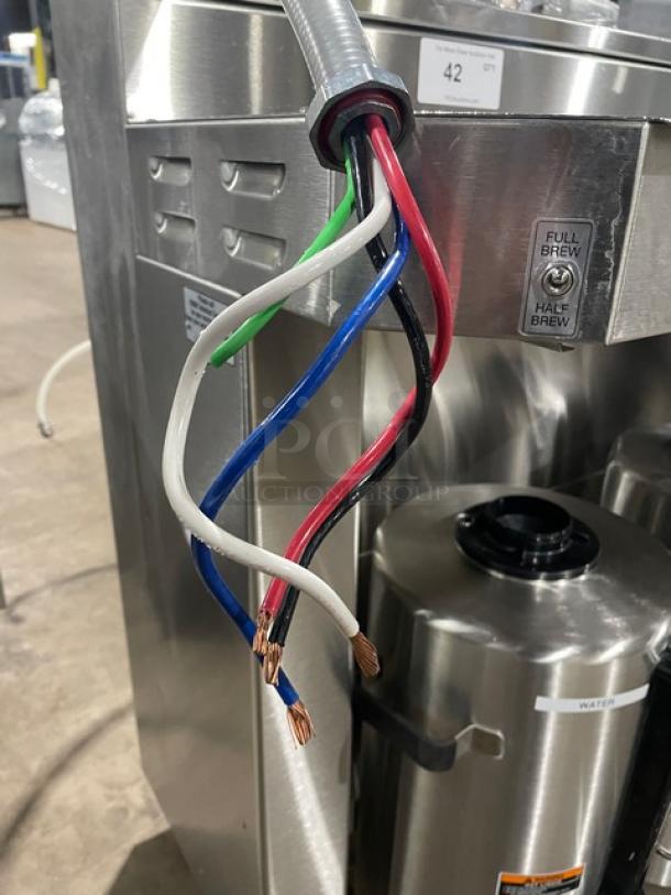 Fetco CBS-62H commercial stainless steel twin coffee brewer with hot water dispenser, wires exposed, 240V, 1 phase.