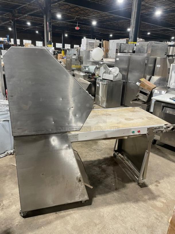TMB Baking commercial stainless steel electric dough sheeter, floor model, on casters, industrial setting, used condition.