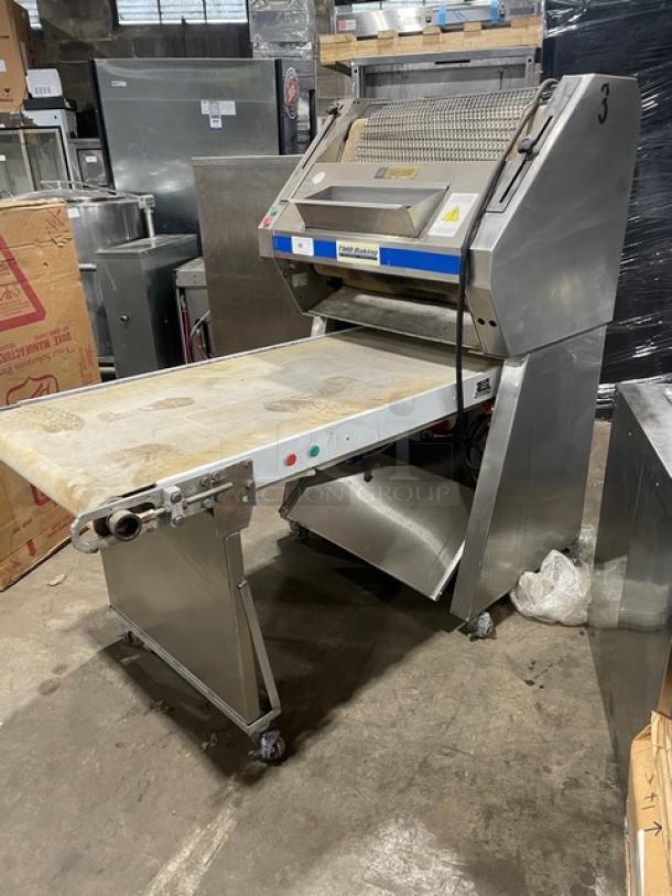 TMB Baking stainless steel electric dough sheeter on casters, floor model. Features accessible controls and sturdy build.