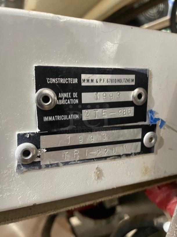 TMB Baking stainless steel electric dough sheeter, floor model on casters. Manufacturer label shows 1993. TRI-220V power.