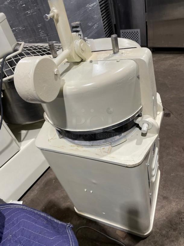 Commercial white electric dough rounder/divider, durable condition, with adjustable settings and metal components, ideal for bakeries.