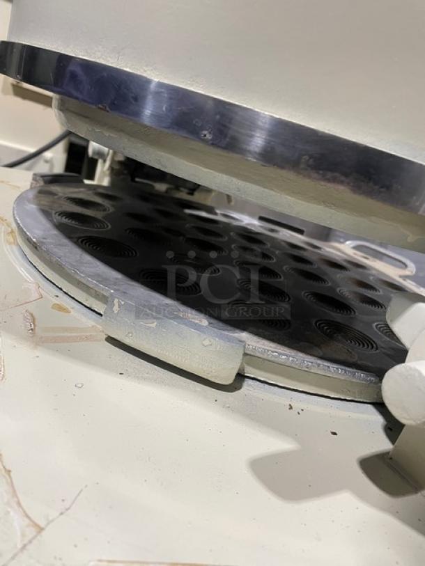 Commercial white electric dough rounder/divider in used condition; features stainless steel elements, suitable for high-output bakery operations.