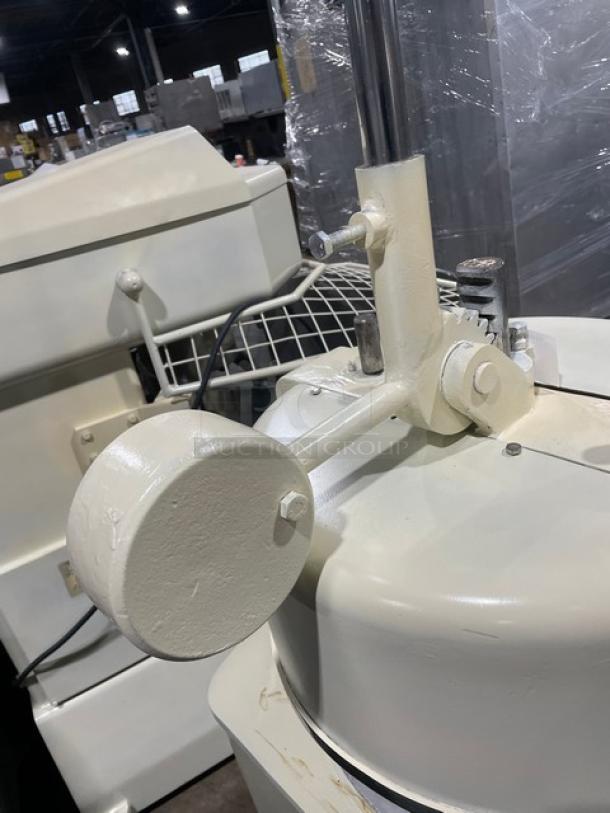 Commercial white electric dough rounder/divider, sturdy metal construction, light wear, ideal for bakery use.