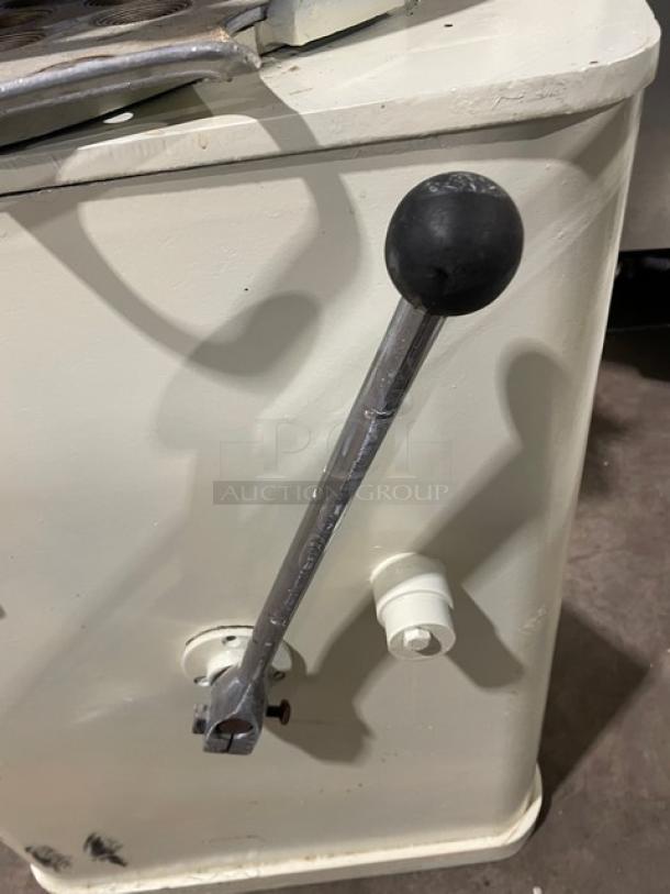 Commercial white electric dough rounder/divider with metal lever, shown in used condition. Ideal for kitchen use.