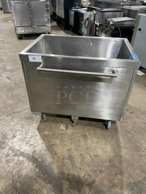 Stainless steel portable ice bin on casters, commercial-grade, features a large handle, appears in good condition.