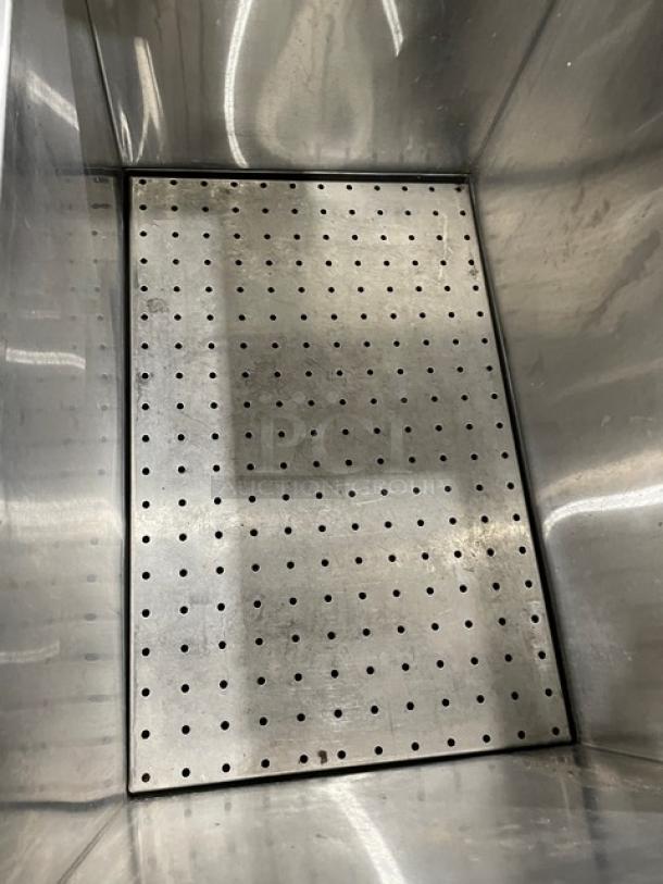 Commercial stainless steel portable ice bin with perforated bottom, on casters, good condition.