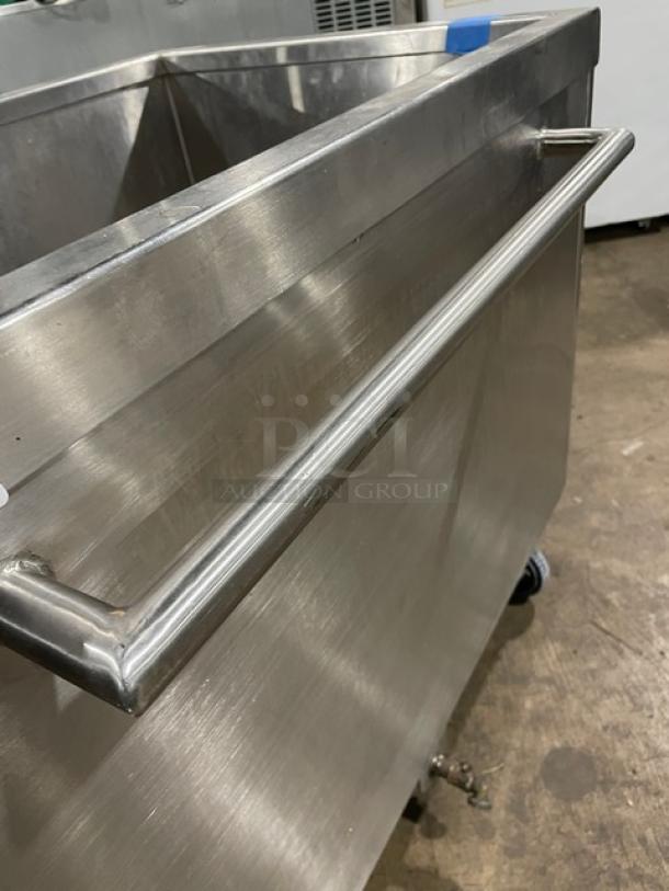 Commercial stainless steel portable ice bin with casters; features handle for easy mobility. Good condition.