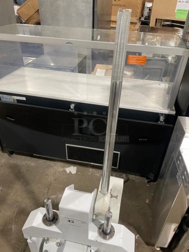 Migsa manual dough divider with single undershelf, stainless steel bowl, on legs; white, commercial-grade.