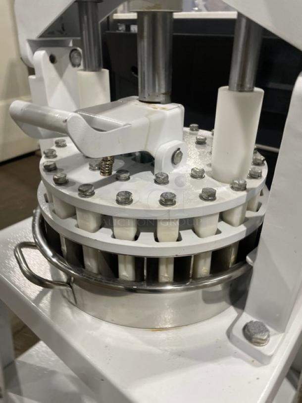 Migsa commercial manual dough divider with white finish, stainless steel bowl, single undershelf, and sturdy legs.