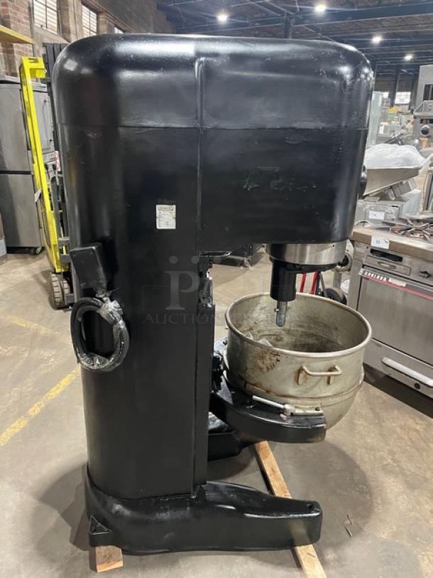 Hobart M802 commercial black floor-model dough mixer with 80 qt. bowl and flat beater, 200V 3 phase, on legs.