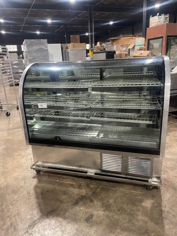 Marc commercial stainless steel bakery display case, curved glass, multi-tier, poly-coated wired rack, rear sliding doors, on casters.