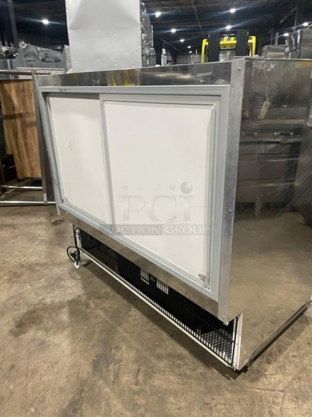 Marc refrigerated bakery display case with stainless steel and curved glass design. Features poly coated rack, sliding rear doors, and casters.