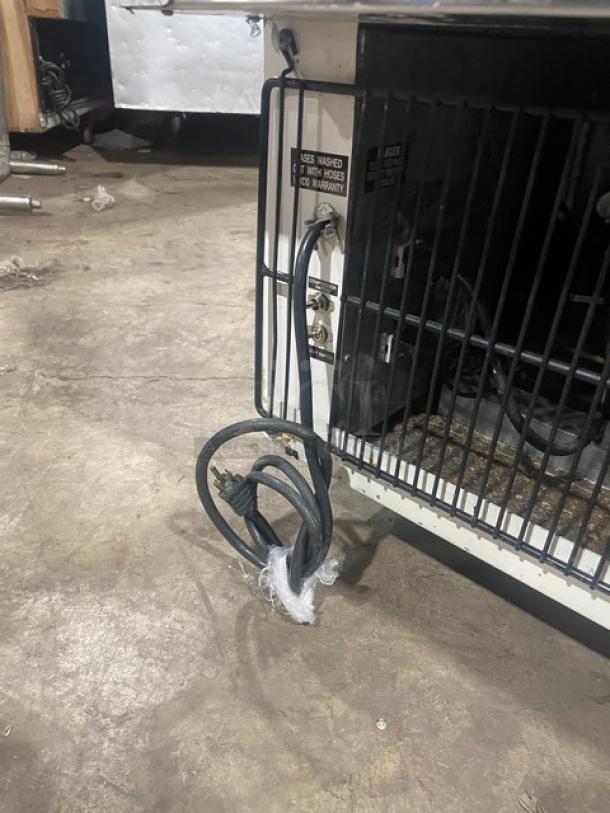 Marc commercial stainless steel refrigerated display case, showing rear wiring and label for warranty and installation.