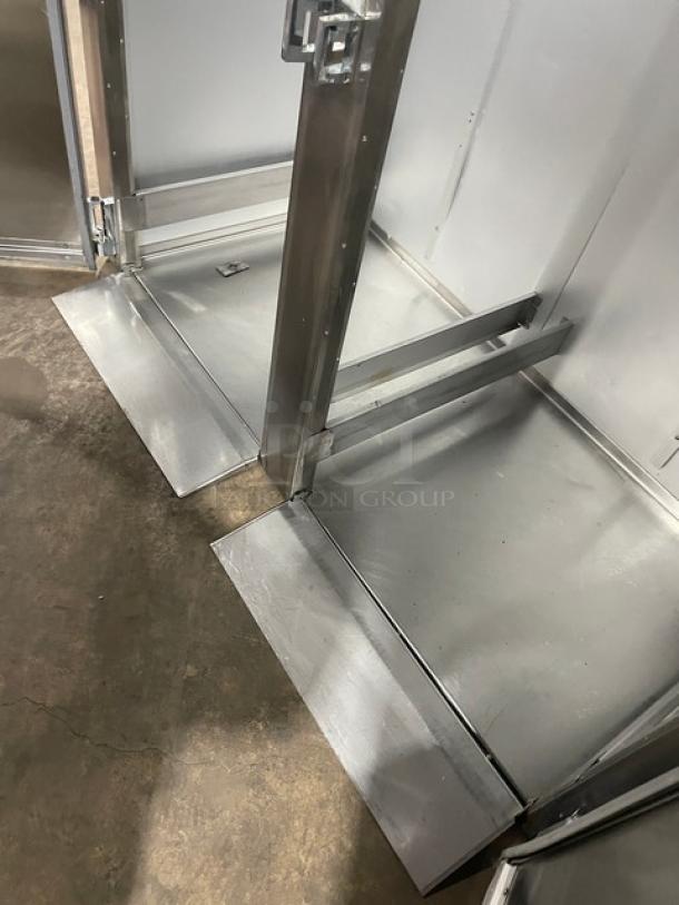 Traulsen stainless steel 2 door roll-in refrigerator, model ARI232LUTFHS, showcasing interior roll-in area. Energy Star certified.