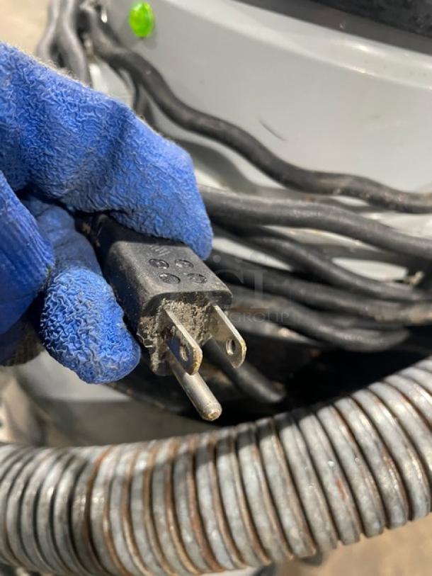 Nilfisk CFM Model 118 industrial vacuum cleaner; 120V, serial number 15A1634, on casters, with power plug.