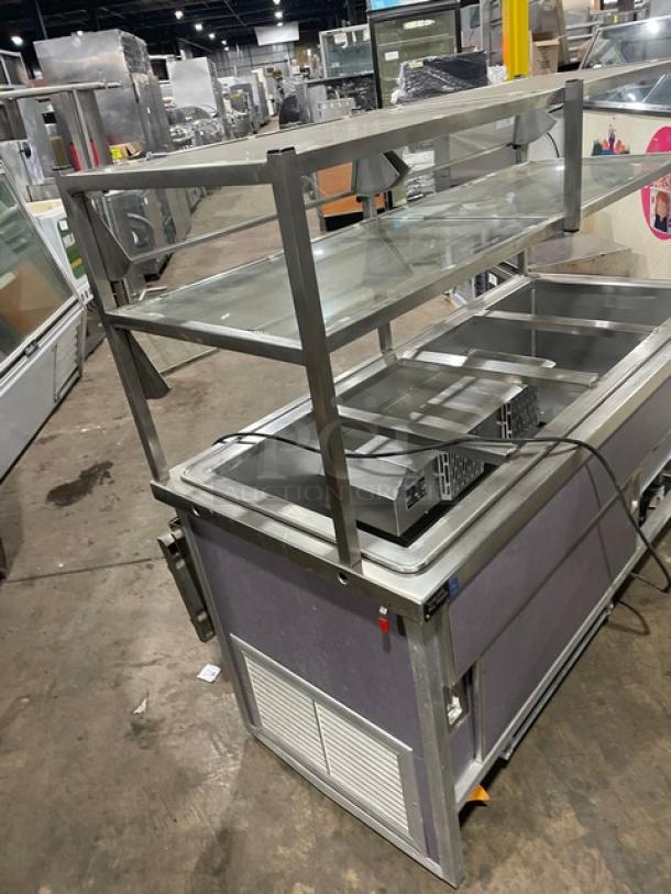 Atlas Metal Model WCMBT4 stainless steel refrigerated 4-well salad bar with sneeze guard and tray slide, on casters.