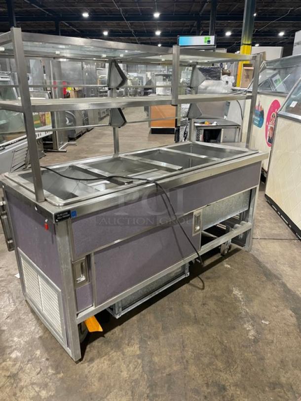 Atlas Metal WCM-BT-4 stainless steel refrigerated cold food salad bar with sneeze guard, tray slide, enclosed storage, and casters.