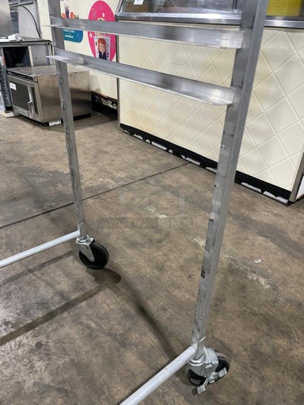 Commercial heavy-duty pan holding/transport rack with casters, metal frame, industrial setting, excellent condition.