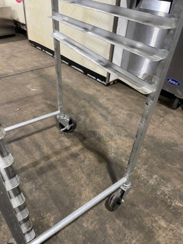Commercial heavy-duty pan rack on casters, metal construction, multiple shelves, suitable for transport, used condition.