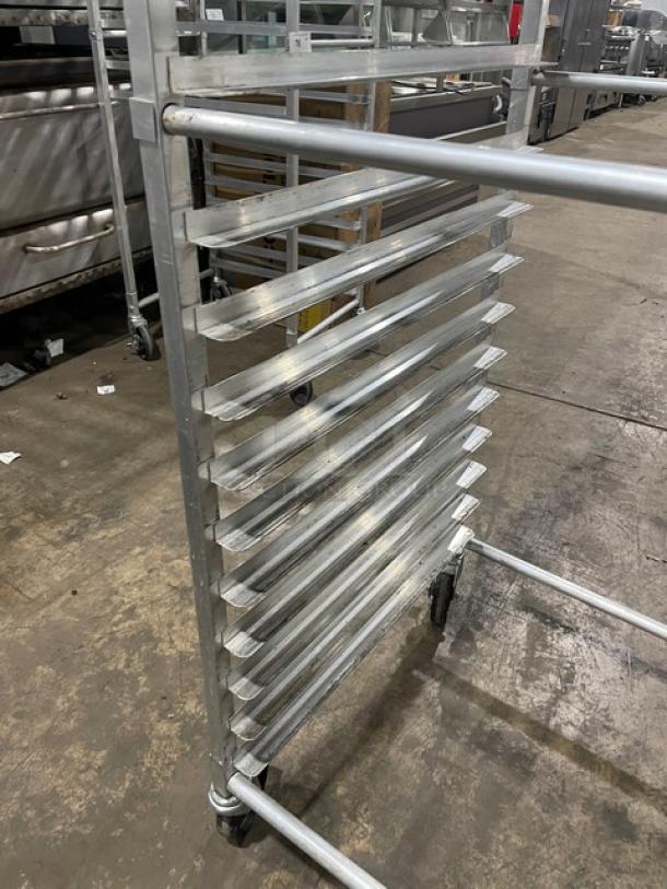 Commercial heavy-duty pan holding rack with multiple shelves, on casters for easy transport. Good condition.