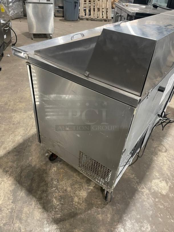 Turbo Air MST-60-24-N stainless steel 2-door refrigerated prep table, bain marie style, on casters, with poly-coated rack.