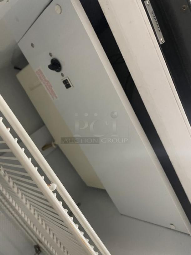 Beverage-Air MT27 commercial refrigerator interior, showing poly-coated wire rack, model details, with power settings visible.