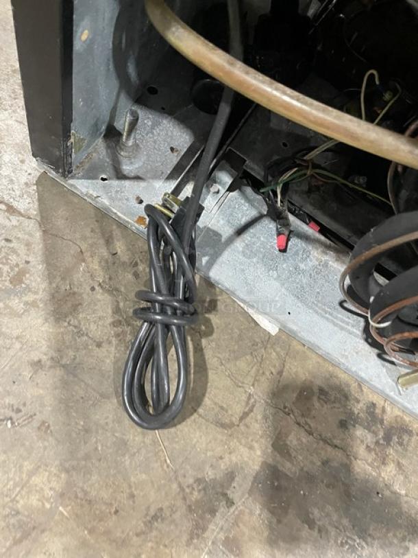 Beverage-Air MT27 refrigerator base view showing electrical cord and internal components. Model MT27, SN: 6458494.