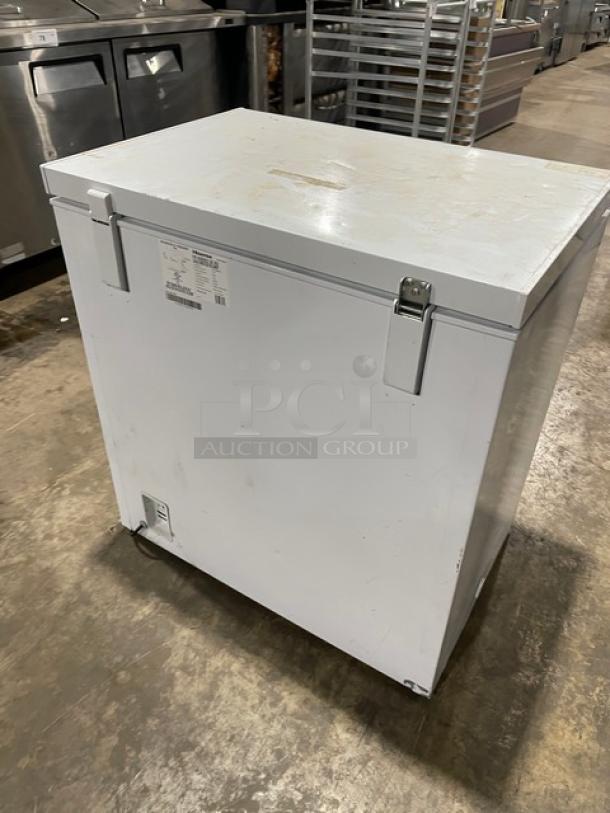 Hisense white chest freezer WFC070M6RWD, 115V, commercial use. Visible wear, metal hinges, and safety label on front.
