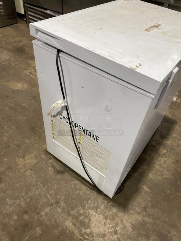 Hisense commercial white horizontal chest freezer, model WFC070M6RWD, 115V. Visible wear. Cyclopentane marking on side.