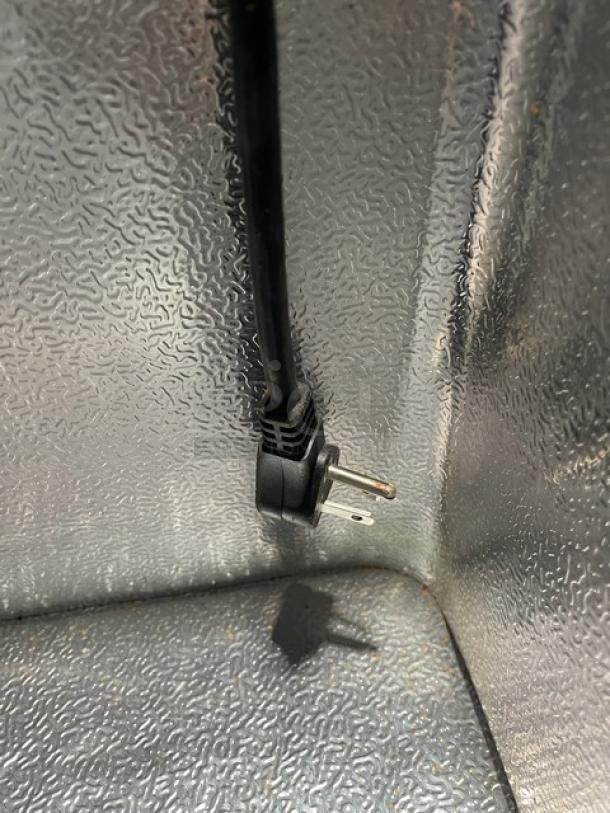 Hisense Commercial Chest Freezer plug detail, model WFC070M6RWD, shows interior texture and 115V power compatibility.