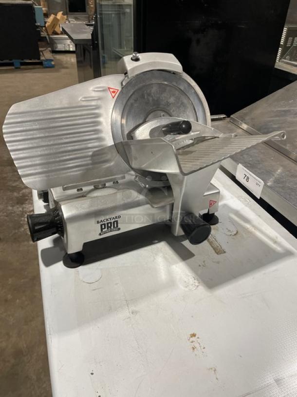 Backyard Pro Commercial 9" deli/meat slicer, model 554SL109E, in good condition. Electric-powered, 120V, metal housing.