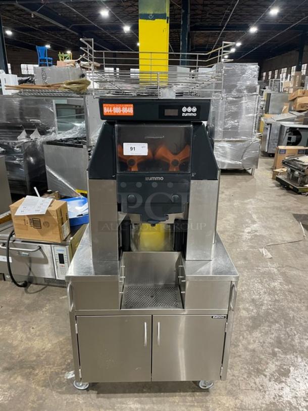 Zummo Z40CN Nature Adapt Series commercial orange juicer on casters, stainless steel with drip tray, model visible.