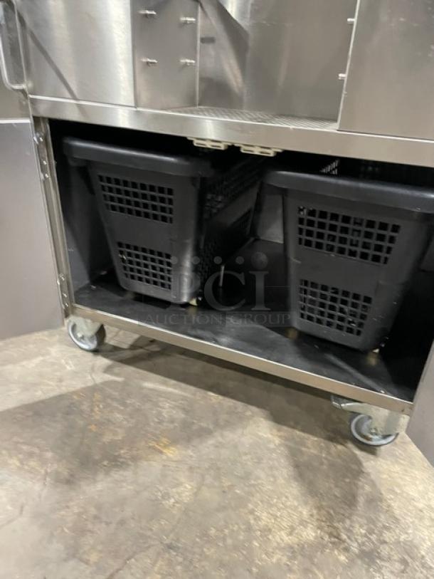 Zummo Z40CN electric citrus juicer with drip tray on casters, features stainless steel construction and dual cabinet design.