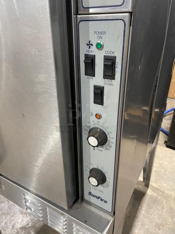 SunFire stainless steel gas convection oven with controls, single stack, wired rack, on legs. In good condition.