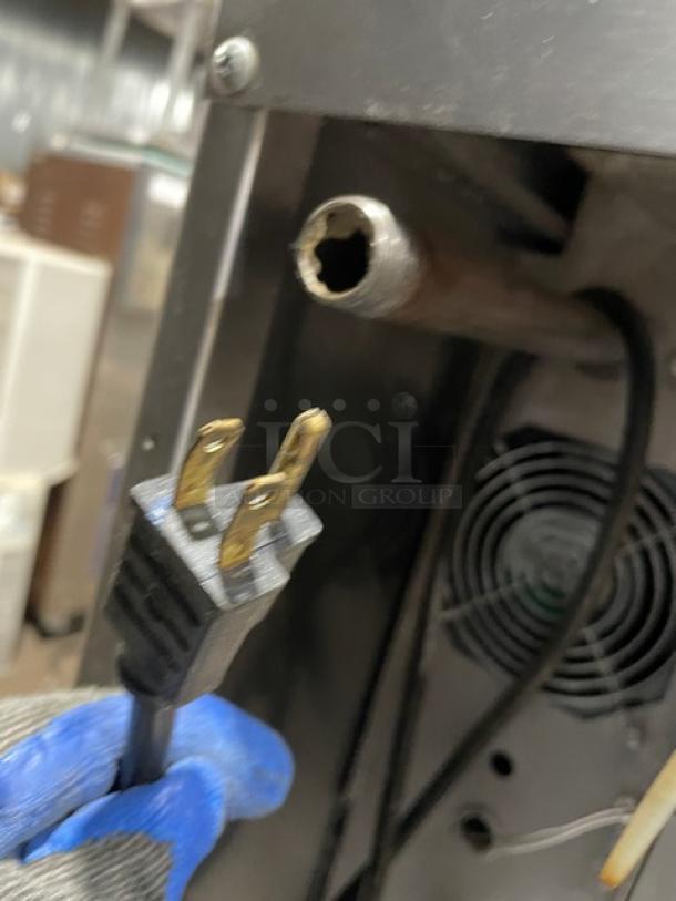 SunFire commercial convection oven back view, showcasing power plug and wiring. Stainless steel condition is visible.