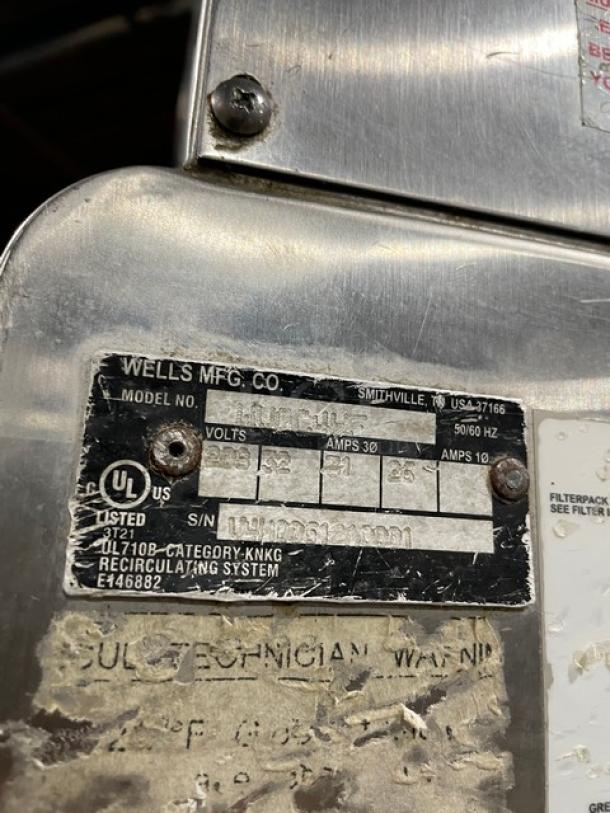 Wells VCS2000 ventless cooking system label showing model, voltage, and certification details. Stainless steel.