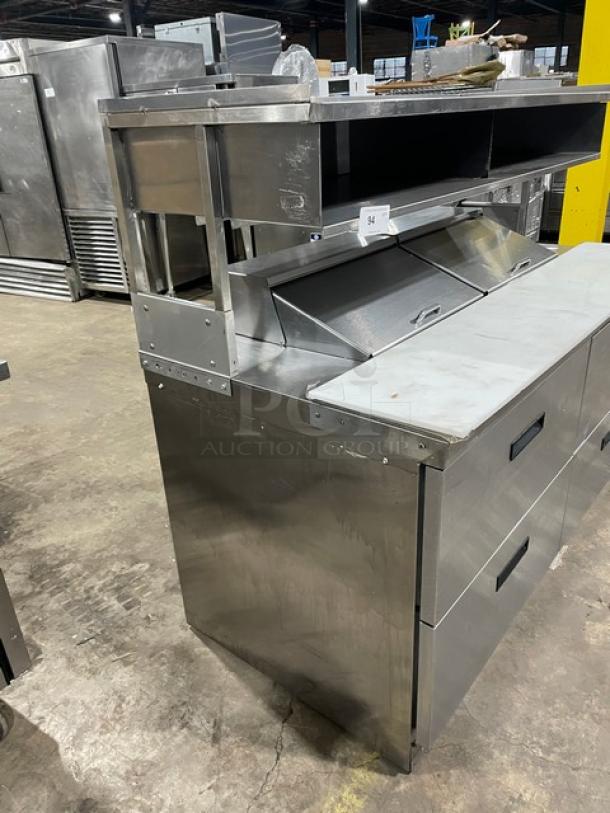 Delfield stainless steel refrigerated prep table with 4 drawers, enclosed shelf, cutting board; Model UCD4464N-12-DD5.