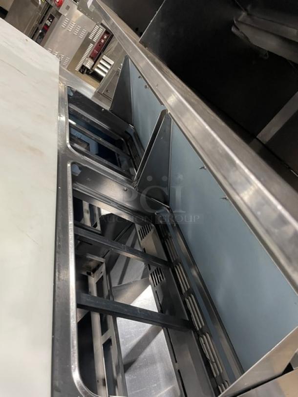 Delfield stainless steel 4-drawer refrigerated prep table, model UCD4464N12DD5, with overhead shelf and cutting board.