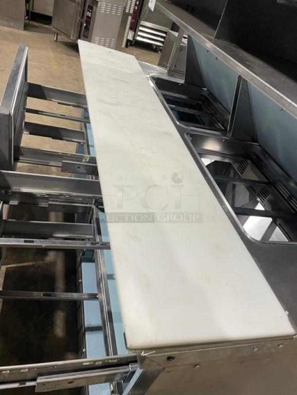 Delfield stainless steel 4-drawer refrigerated prep table with overhead shelf and cutting board, model UCD4464N12DD5.