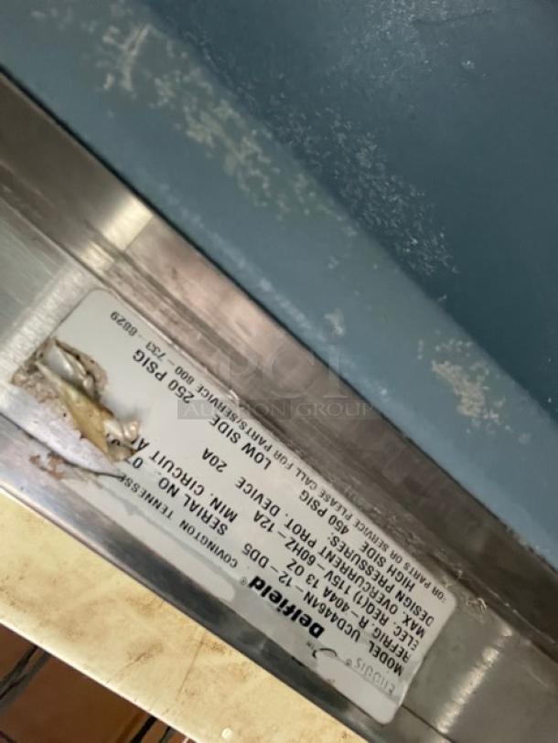 Delfield refrigerated prep table label showing model UCD4464N12DD5, voltage 115V, condition worn.