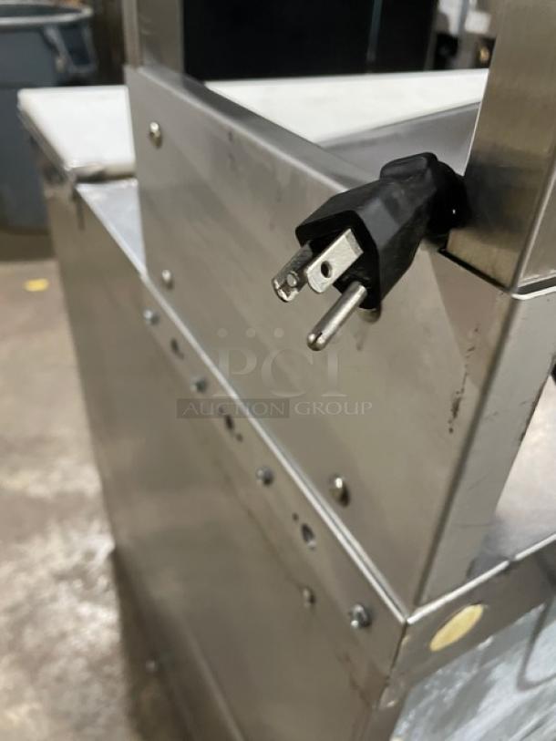 Delfield UCD4464N-12-DD5 stainless steel refrigerated prep table with 4 drawers, overhead shelf, and cutting board. Plug visible.