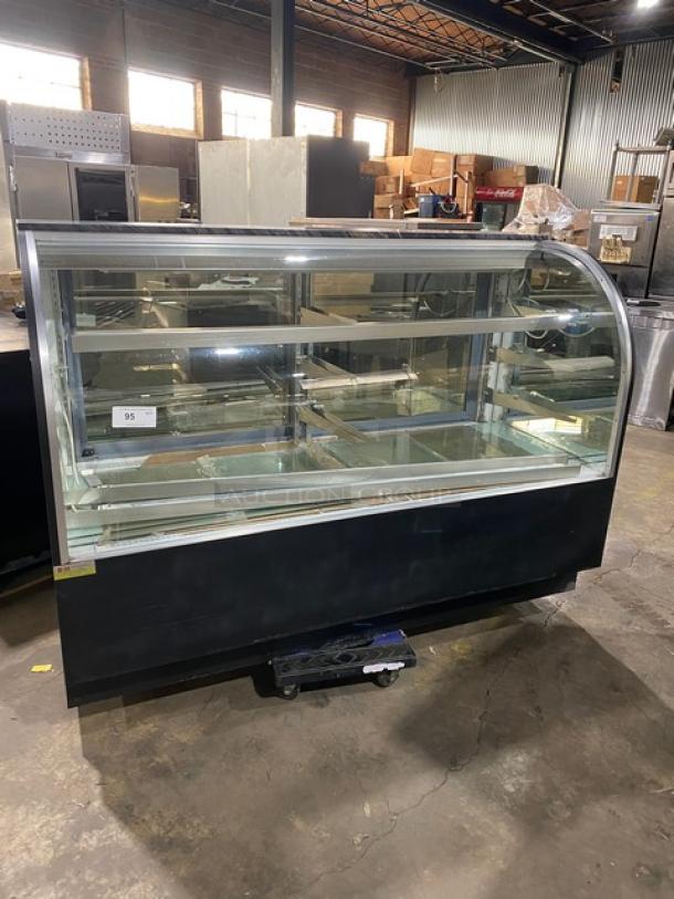 Commercial black curved glass bakery display case with multi-tier shelves, lower compartment, and rear sliding doors.
