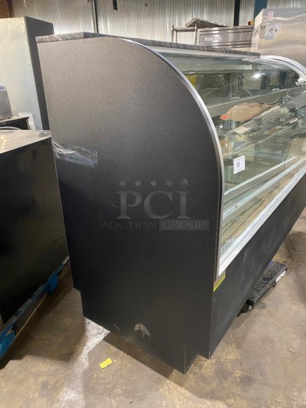 Commercial black curved glass bakery display case with multiple tiers, lower overstock compartment, and rear sliding doors.